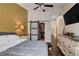 Stylish primary bedroom with a large bed, en-suite bath, walk-in closet, and a modern dresser at 2305 Hot Oak Ridge St, Las Vegas, NV 89134