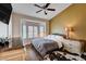 Bright main bedroom featuring a bay window, comfortable bed, modern dresser, and stylish decor at 2305 Hot Oak Ridge St, Las Vegas, NV 89134