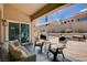 Inviting covered patio with comfortable seating, a barbecue grill, and access to the backyard at 2305 Hot Oak Ridge St, Las Vegas, NV 89134
