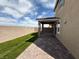A covered patio and an artificial lawn enhance this home's backyard appeal at 2321 Teatro Ave, Henderson, NV 89044