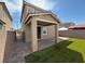 A covered patio extends entertaining space into the backyard, featuring a well maintained artificial lawn at 2321 Teatro Ave, Henderson, NV 89044