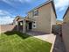 This home's outdoor space features a covered patio and an easy-to-maintain artificial grass lawn at 2321 Teatro Ave, Henderson, NV 89044