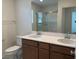 Bathroom features a double sink vanity, modern fixtures, and a glass-enclosed shower, blending style with functionality at 2321 Teatro Ave, Henderson, NV 89044