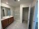Modern bathroom featuring double sinks, a glass shower, and a spacious walk-in closet at 2321 Teatro Ave, Henderson, NV 89044