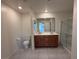 Bright bathroom featuring double sinks, a toilet, and glass shower at 2321 Teatro Ave, Henderson, NV 89044