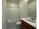 Well-lit bathroom with a shower-tub combo, white tile surround, and a vanity with a white countertop at 2321 Teatro Ave, Henderson, NV 89044