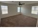 Bedroom with carpet floors, ceiling fan, and multiple windows offering natural light at 2321 Teatro Ave, Henderson, NV 89044