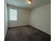 Simple, carpeted bedroom featuring a bright window at 2321 Teatro Ave, Henderson, NV 89044