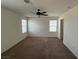 Bedroom with carpet floors, ceiling fan, and windows offering natural light at 2321 Teatro Ave, Henderson, NV 89044