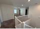 Bright upstairs hallway with carpeted floors and white railings at 2321 Teatro Ave, Henderson, NV 89044