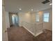 Upstairs hallway with carpet, white railing, and plenty of natural light at 2321 Teatro Ave, Henderson, NV 89044