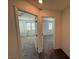 Hallway view with doors leading to bedrooms with carpet flooring and natural light, perfect for Gathering living at 2321 Teatro Ave, Henderson, NV 89044