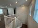 Hallway featuring carpet, white railings, and windows offering natural light at 2321 Teatro Ave, Henderson, NV 89044