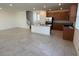 Open kitchen with island, stainless steel appliances, dark brown cabinets, and a seamless flow to the living area at 2321 Teatro Ave, Henderson, NV 89044