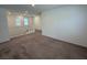 Spacious loft area with carpet flooring and a view of windows, showcasing an open and versatile living space at 2321 Teatro Ave, Henderson, NV 89044