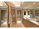 Bright bathroom with a marble countertop vanity, walk-in shower, and separate toilet area at 2747 Paradise Rd # 1703, Las Vegas, NV 89109