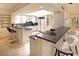 Bright kitchen with white cabinetry, granite countertops, bar seating, and modern appliances at 2747 Paradise Rd # 1703, Las Vegas, NV 89109