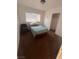 Small bedroom with a single bed, chair and window, providing natural light at 2820 Fort Sumter Dr, North Las Vegas, NV 89030