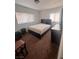 Bedroom with a dark bed frame, side dresser, carpet flooring, and windows at 2820 Fort Sumter Dr, North Las Vegas, NV 89030