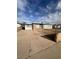 Single story home with a driveway and desert landscaping under a cloudy blue sky at 2820 Fort Sumter Dr, North Las Vegas, NV 89030