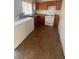 Functional kitchen with a gas stove, washer, dryer, and wooden cabinets at 2820 Fort Sumter Dr, North Las Vegas, NV 89030