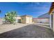Backyard featuring detached garage with side door, landscaping and perimeter block wall at 2832 Geist Cir, Las Vegas, NV 89115