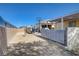 Spacious backyard featuring block wall perimeter, covered patio, basketball hoop, and detached garage at 2832 Geist Cir, Las Vegas, NV 89115