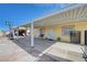Backyard view of the covered patio with basketball hoop, leading to a detached garage, providing ample space at 2832 Geist Cir, Las Vegas, NV 89115