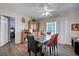 Spacious dining room features hardwood floors, a ceiling fan, and a large window for natural light, ideal for Gathering gatherings at 2832 Geist Cir, Las Vegas, NV 89115