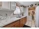 Bright kitchen features granite counters, stainless steel sink, and tile floors; plus a washer/dryer in separate room at 2832 Geist Cir, Las Vegas, NV 89115