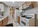 Bright kitchen features granite counters, stainless steel appliances, tile floors; plus a washer/dryer in separate room at 2832 Geist Cir, Las Vegas, NV 89115