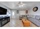 Cozy living room with tile flooring, comfy seating, and a modern TV at 2832 Geist Cir, Las Vegas, NV 89115