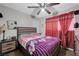 Cozy main bedroom features carpet floors, a ceiling fan, and lots of light at 2832 Geist Cir, Las Vegas, NV 89115