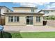 Backyard area with brick patio, artificial grass, and sliding glass doors at 2877 Sweeping Palm Rd, North Las Vegas, NV 89086