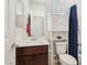 Bathroom with vanity, mirror, toilet, and tub/shower with blue curtain and white storage unit at 2877 Sweeping Palm Rd, North Las Vegas, NV 89086