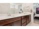 Bathroom features double sink vanity with dark wood cabinets, a full mirror, and white countertops at 2877 Sweeping Palm Rd, North Las Vegas, NV 89086