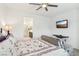 Bright bedroom includes a bed, seating, TV, and access to the en-suite bathroom with vanity and mirror at 2877 Sweeping Palm Rd, North Las Vegas, NV 89086