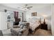 Comfortable bedroom with a ceiling fan, large window, and cozy armchair at 2877 Sweeping Palm Rd, North Las Vegas, NV 89086