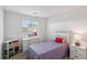Bright bedroom with a twin bed, white furniture, and natural light from the window at 2877 Sweeping Palm Rd, North Las Vegas, NV 89086