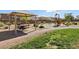 Charming community playground with a picnic area, vibrant play structures, and lush green surroundings at 2877 Sweeping Palm Rd, North Las Vegas, NV 89086