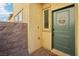 Welcoming front entryway featuring a sage green door and custom 'Home' decor at 2877 Sweeping Palm Rd, North Las Vegas, NV 89086