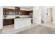 Spacious open kitchen with stainless steel appliances, central island and dark wood cabinets at 2877 Sweeping Palm Rd, North Las Vegas, NV 89086