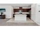 Open kitchen with a center island, stainless steel appliances, and dark wood cabinets at 2877 Sweeping Palm Rd, North Las Vegas, NV 89086