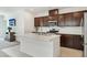 Bright kitchen with a large island, stainless steel appliances, and dark wood cabinetry at 2877 Sweeping Palm Rd, North Las Vegas, NV 89086
