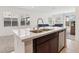 Kitchen island with stainless steel sink and dark wood cabinets beneath at 2877 Sweeping Palm Rd, North Las Vegas, NV 89086