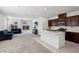 Open-concept kitchen with dark wood cabinets, stainless steel appliances and island at 2877 Sweeping Palm Rd, North Las Vegas, NV 89086