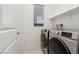 Clean laundry room with modern appliances and a bright window at 2877 Sweeping Palm Rd, North Las Vegas, NV 89086