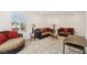 Spacious living room with plush seating, neutral carpet, and bright natural light from the window at 2877 Sweeping Palm Rd, North Las Vegas, NV 89086