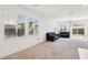 Inviting living room with plush carpeting, large windows, and neutral tones, perfect for relaxing or entertaining guests at 2877 Sweeping Palm Rd, North Las Vegas, NV 89086