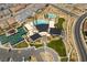 Aerial view of community clubhouse with pool, tennis courts, landscaping and surrounding neighborhood at 3000 Dusky Willow Ln, Las Vegas, NV 89138